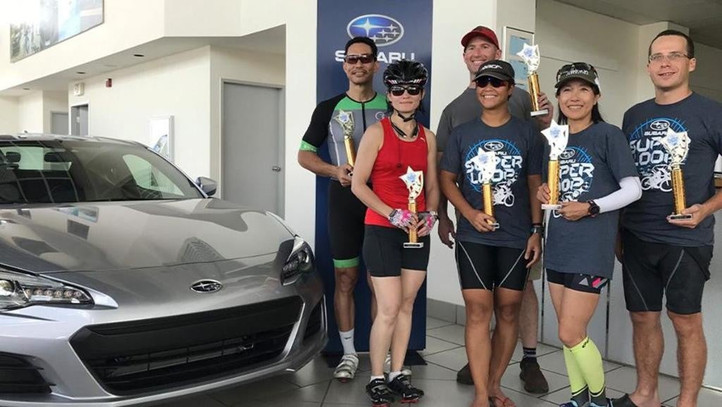 Subaru Superloop participants posing with their awards and prizes